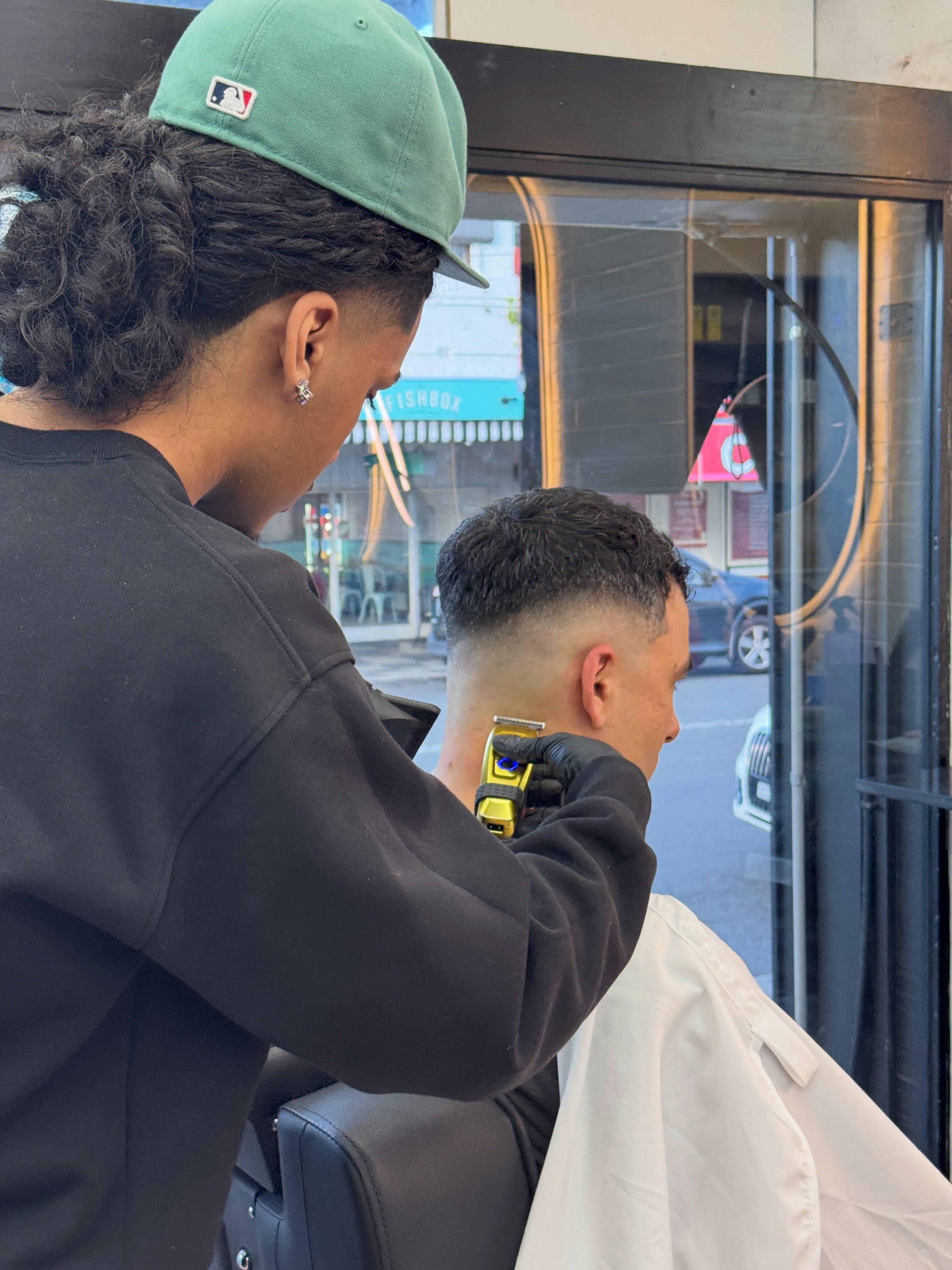 Barber lining up a beard with clippers
